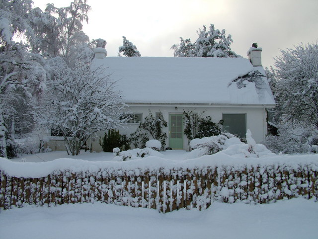 A small house covered in snow