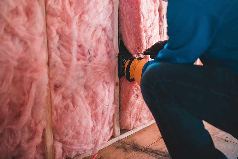 Photo a person inspecting fiberglass insulation